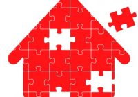 Puzzle in shape of a red house with pieces missing